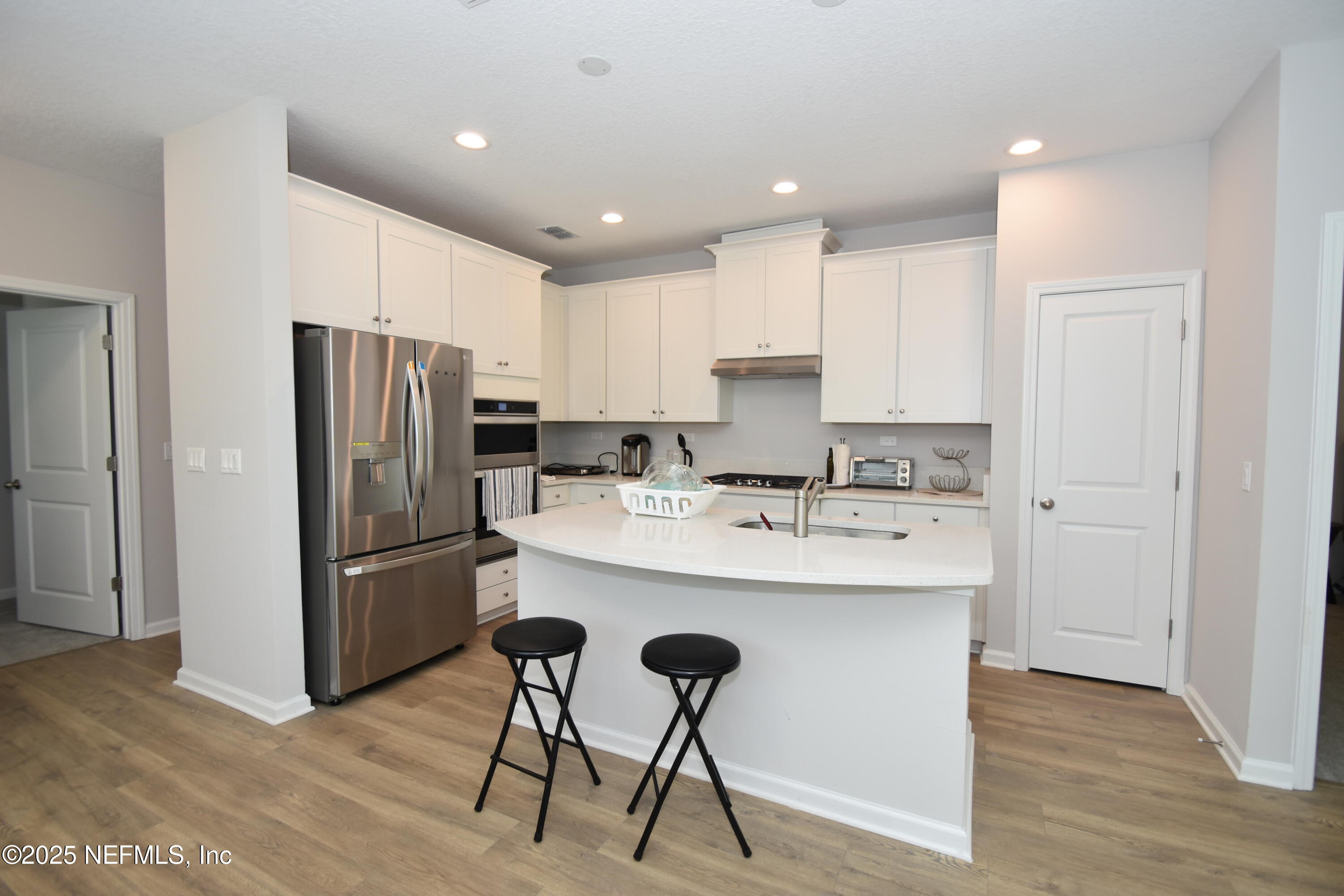 172 Charlie Way St. Augustine, FL 32095 - Photo 6 of 29 a kitchen with kitchen island a appliances a sink and a refrigerator