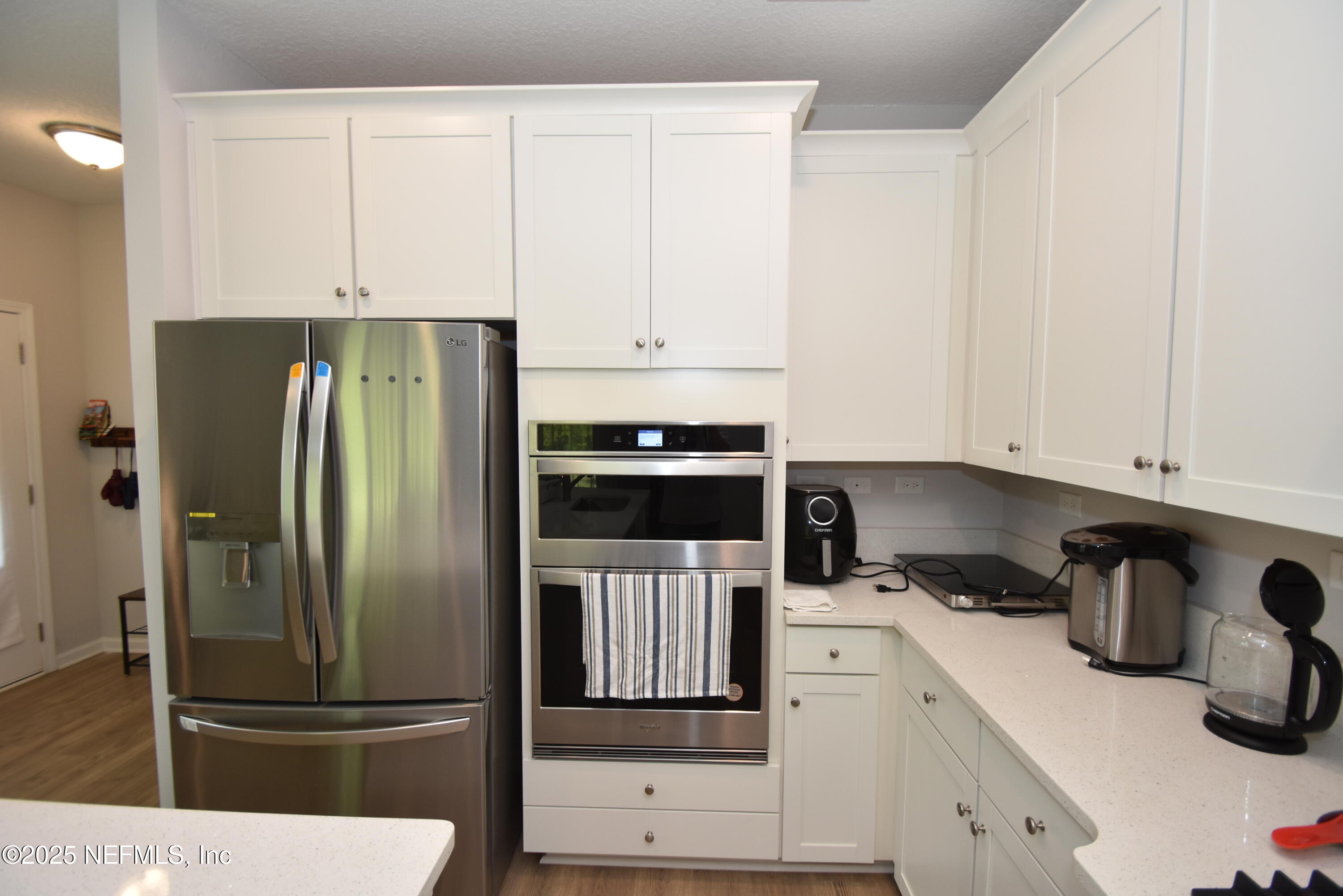 172 Charlie Way St. Augustine, FL 32095 - Photo 8 of 29 a kitchen with a refrigerator and white cabinets