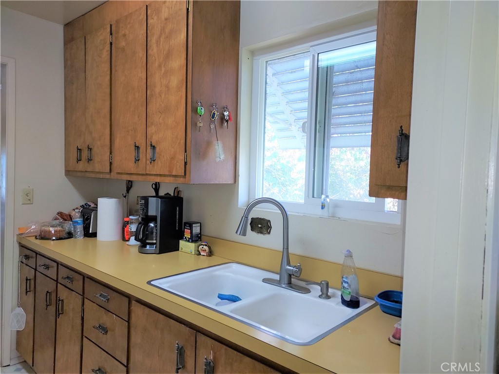 13632 Arrowhead Road Clearlake, CA 95422 - Photo 8 of 28 a kitchen with a sink cabinets and a window