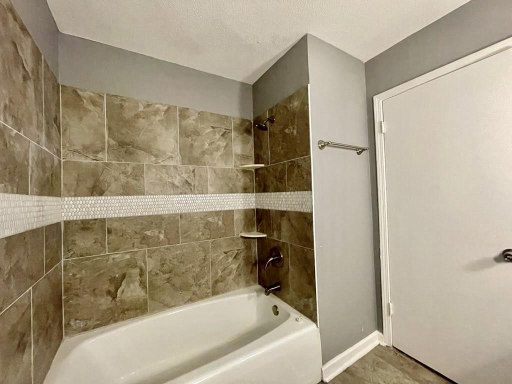 4715 Stage Road Memphis, TN 38128 - Photo 13 of 22 a bathroom with a bathtub and a shower