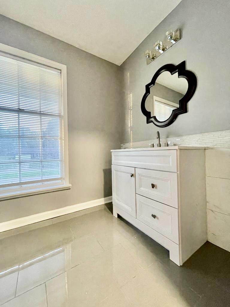4715 Stage Road Memphis, TN 38128 - Photo 18 of 22 a bathroom with a sink a light fixture and a mirror