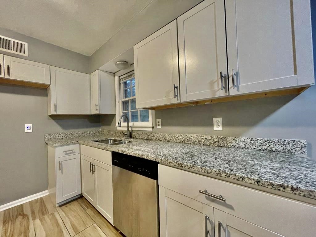 4715 Stage Road Memphis, TN 38128 - Photo 3 of 22 a kitchen with granite countertop cabinets stainless steel appliances and a counter space