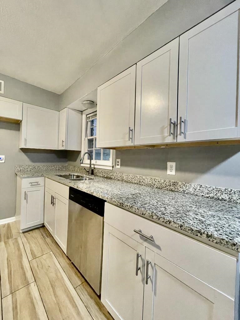 4715 Stage Road Memphis, TN 38128 - Photo 4 of 22 a kitchen with granite countertop a sink a stove and cabinets
