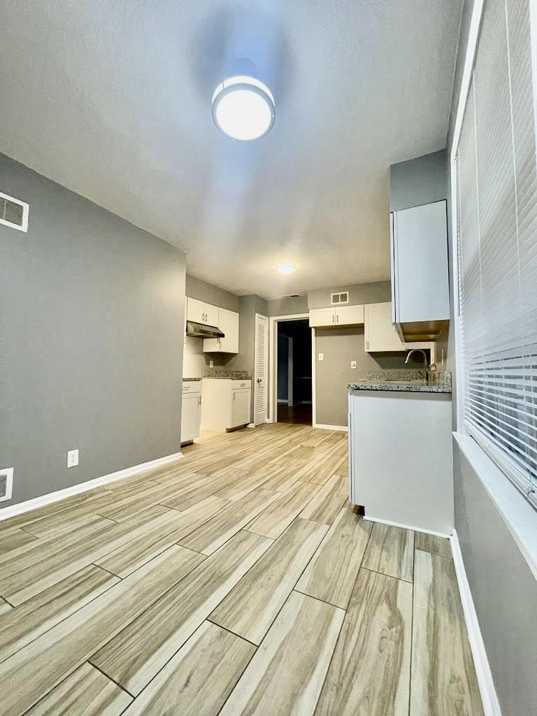 4715 Stage Road Memphis, TN 38128 - Photo 5 of 22 a kitchen with granite countertop white cabinets and stainless steel appliances
