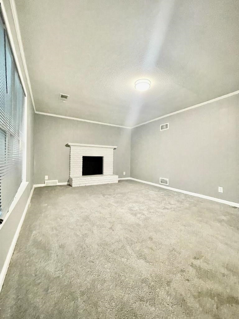 4715 Stage Road Memphis, TN 38128 - Photo 8 of 22 an empty room with a fireplace and windows