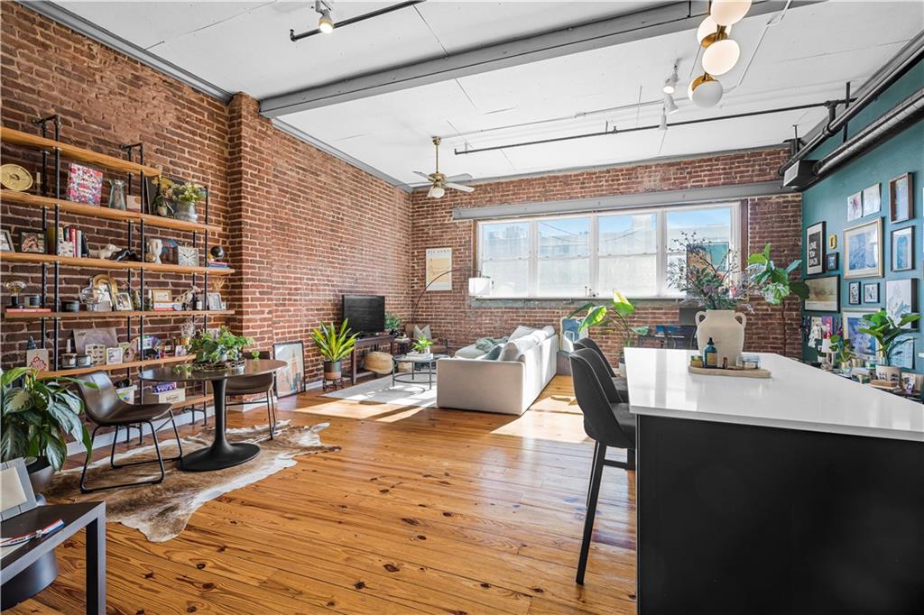 a living room with furniture and a potted plant