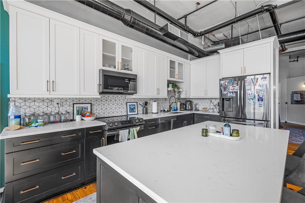 150 Walker Street Southwest, Unit 7 Atlanta, GA 30313 - Photo 11 of 17 a kitchen with a sink a stove and refrigerator