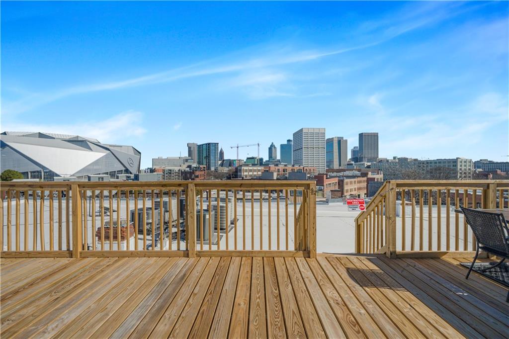 150 Walker Street Southwest, Unit 7 Atlanta, GA 30313 - Photo 16 of 17 a view of a roof deck with wooden floor and city view