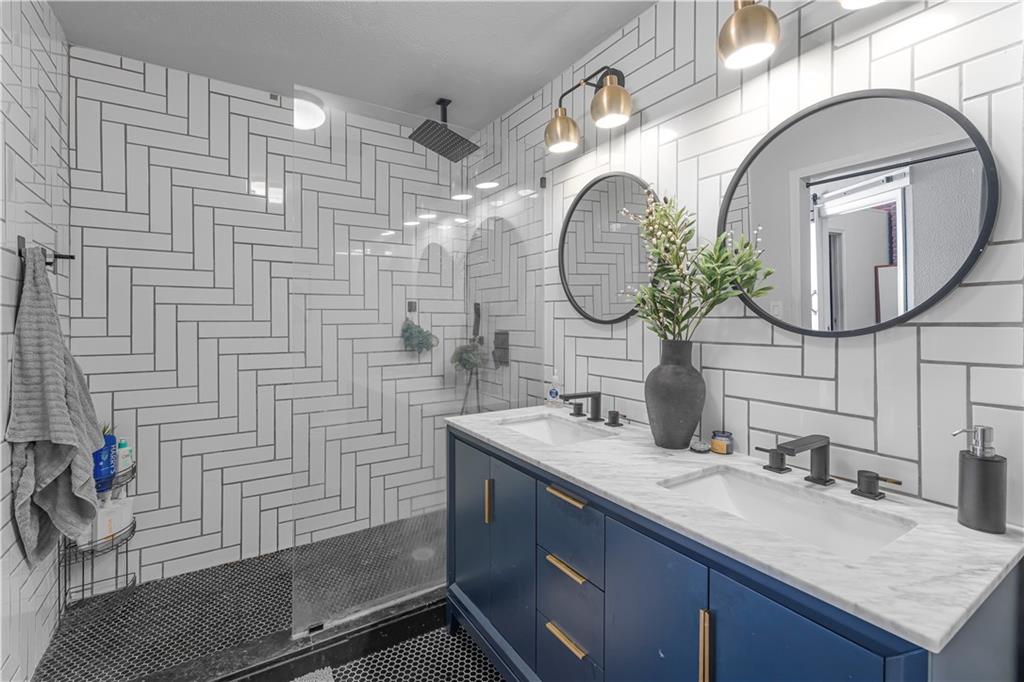 150 Walker Street Southwest, Unit 7 Atlanta, GA 30313 - Photo 6 of 17 a bathroom with a granite countertop sink a mirror and vanity