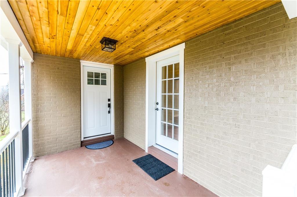 Front Covered Porch has doors leading to the dining room and living room.