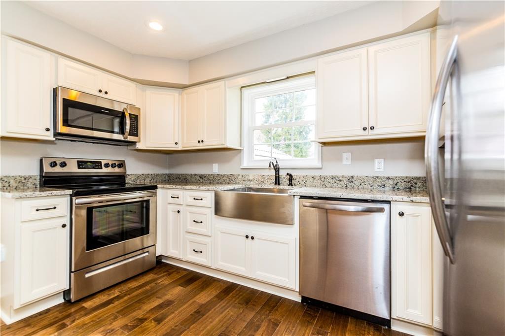 Kitchen with stainless farmhouse sink.