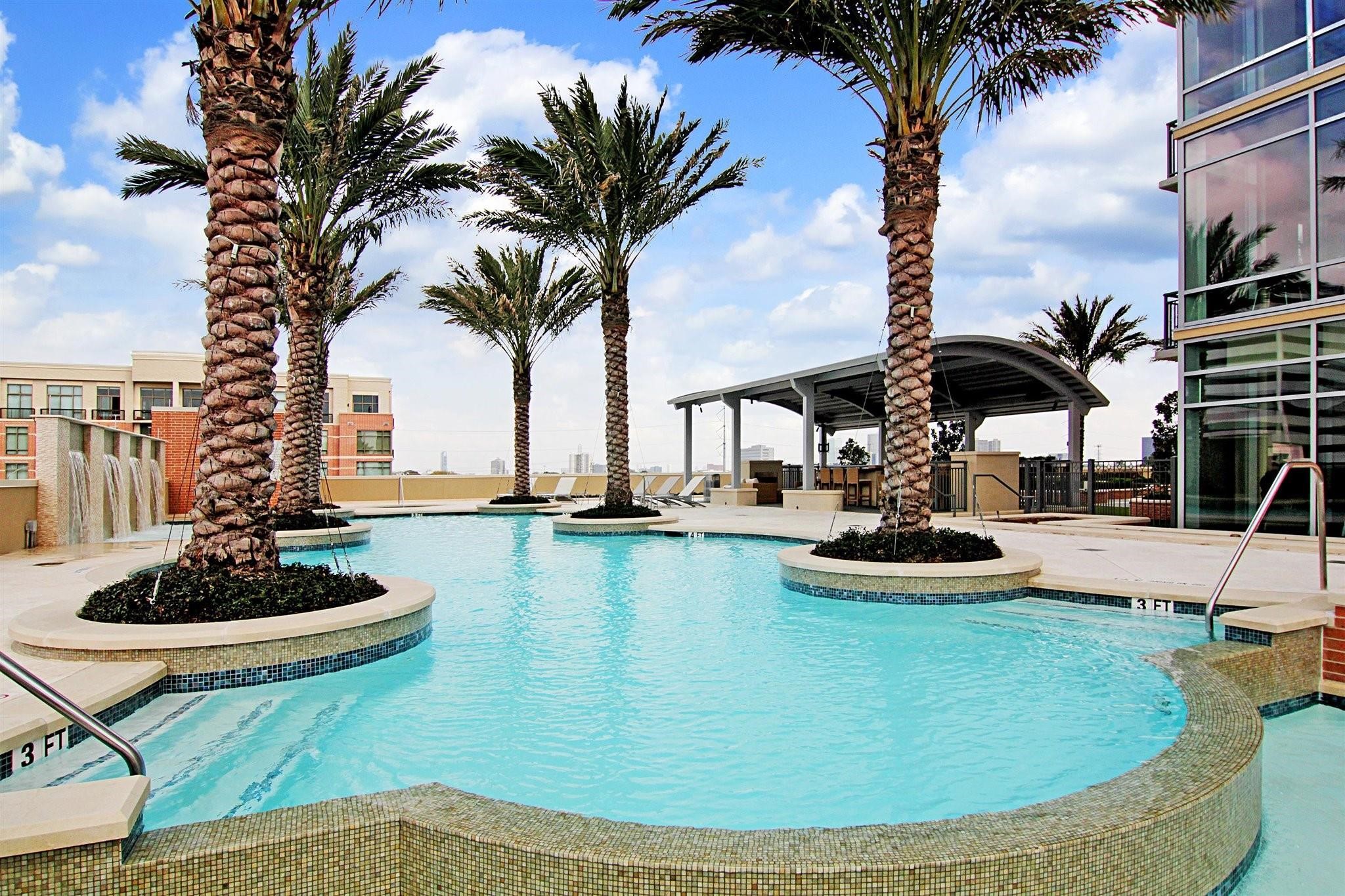 2207 Bancroft Lane, Unit 604 Houston, TX 77027 - Photo 2 of 40 a view of a swimming pool with a table and chairs