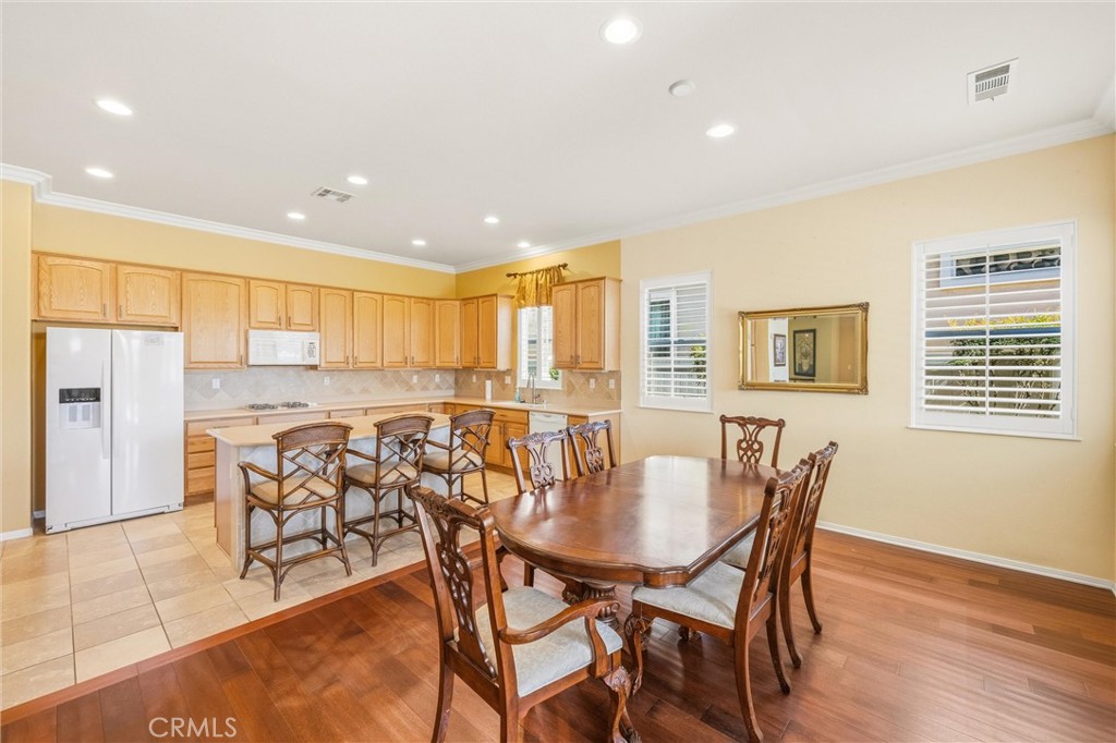 1732 Brittney Road Beaumont, CA 92223 - Photo 12 of 54 a dining room with furniture and wooden floor