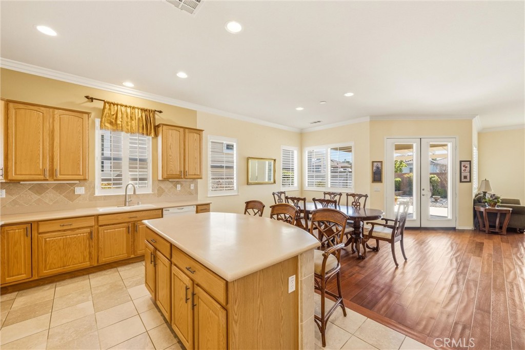 1732 Brittney Road Beaumont, CA 92223 - Photo 17 of 54 a large kitchen with kitchen island a large window a sink and counter space