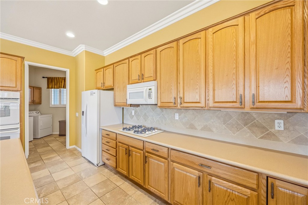 1732 Brittney Road Beaumont, CA 92223 - Photo 20 of 54 a kitchen with stainless steel appliances granite countertop a refrigerator and cabinets
