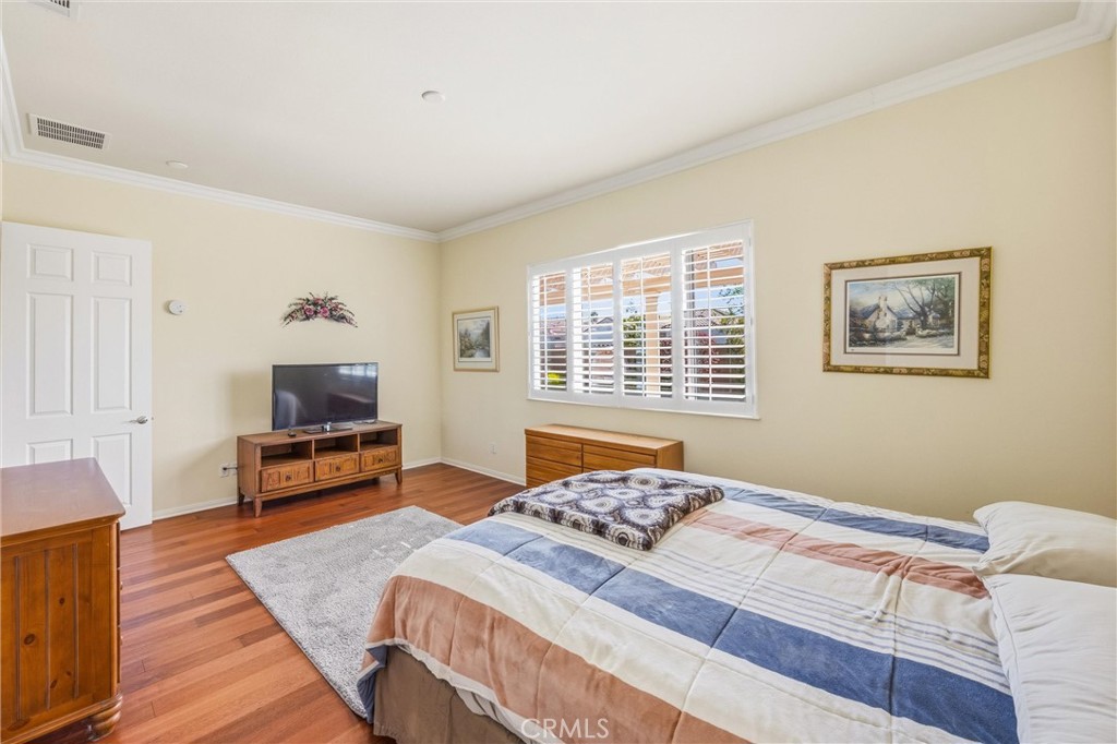 1732 Brittney Road Beaumont, CA 92223 - Photo 24 of 54 a bedroom with a bed and wooden floor