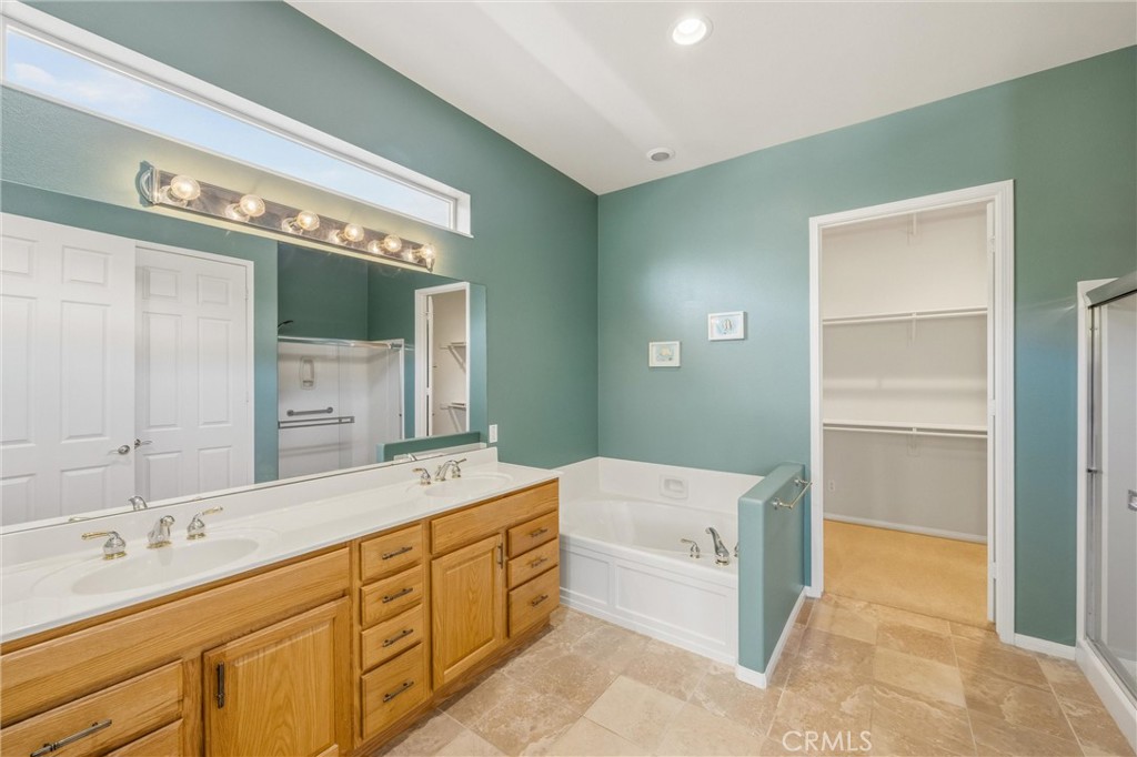 1732 Brittney Road Beaumont, CA 92223 - Photo 25 of 54 a spacious bathroom with a tub sink and mirror