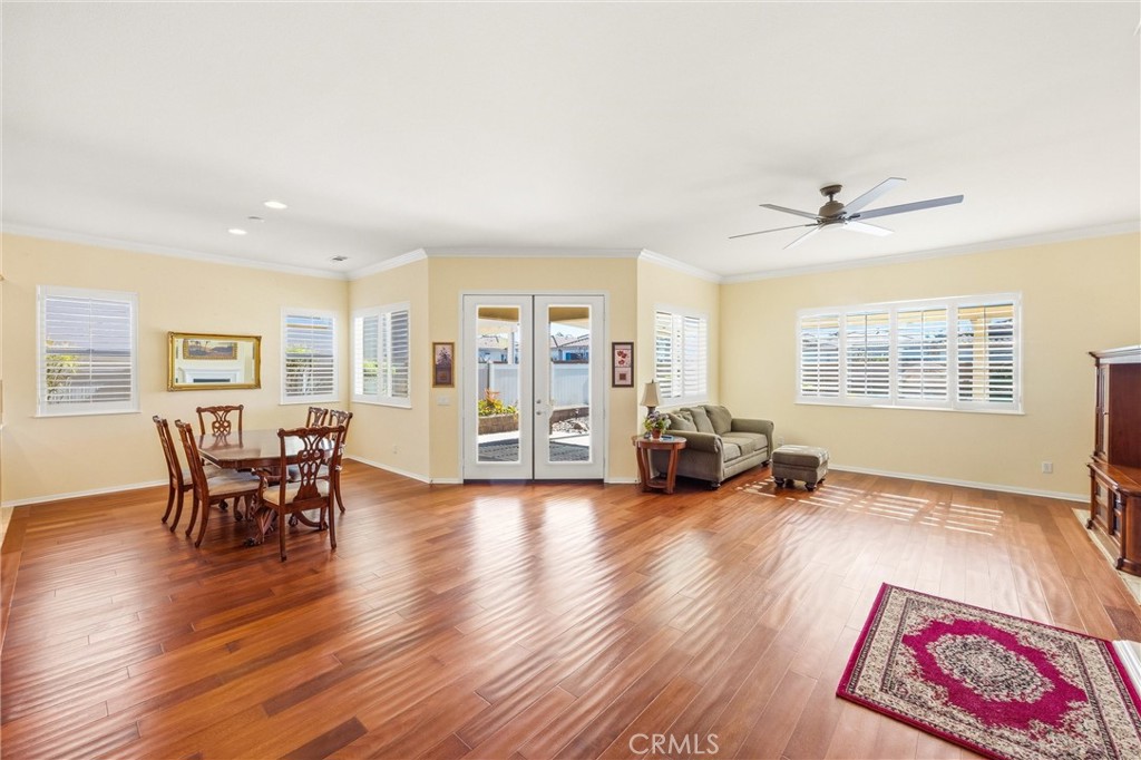 1732 Brittney Road Beaumont, CA 92223 - Photo 31 of 54 a view of a livingroom with furniture a ceiling fan and wooden floor