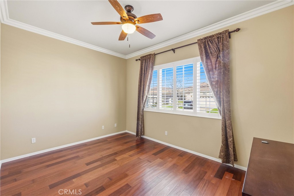1732 Brittney Road Beaumont, CA 92223 - Photo 33 of 54 an empty room with wooden floor fan and windows