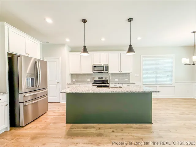 a kitchen with granite countertop wooden floor a fireplace and a counter top space
