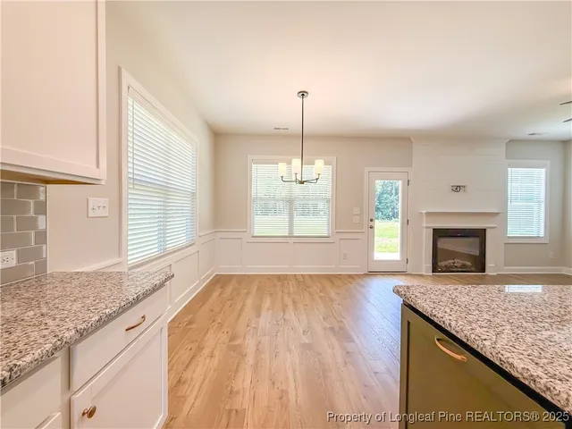 a view of an empty room with a fireplace and a window