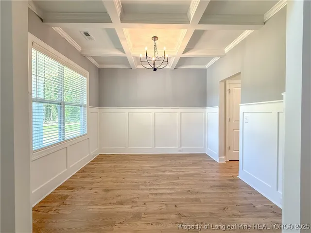 a view of a refrigerator in kitchen and wooden floor