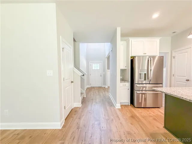 a kitchen with stainless steel appliances granite countertop a refrigerator a sink and a stove