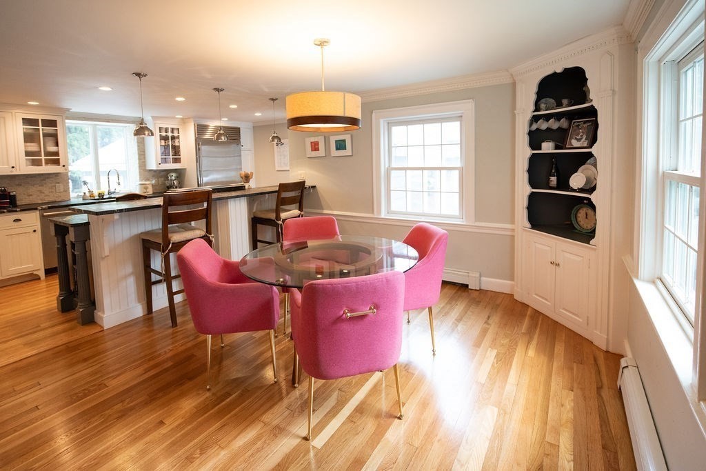 17 Eliot Road Belmont, MA 02478 - Photo 11 of 37 a dining room with kitchen island stainless steel appliances furniture a window and wooden floor