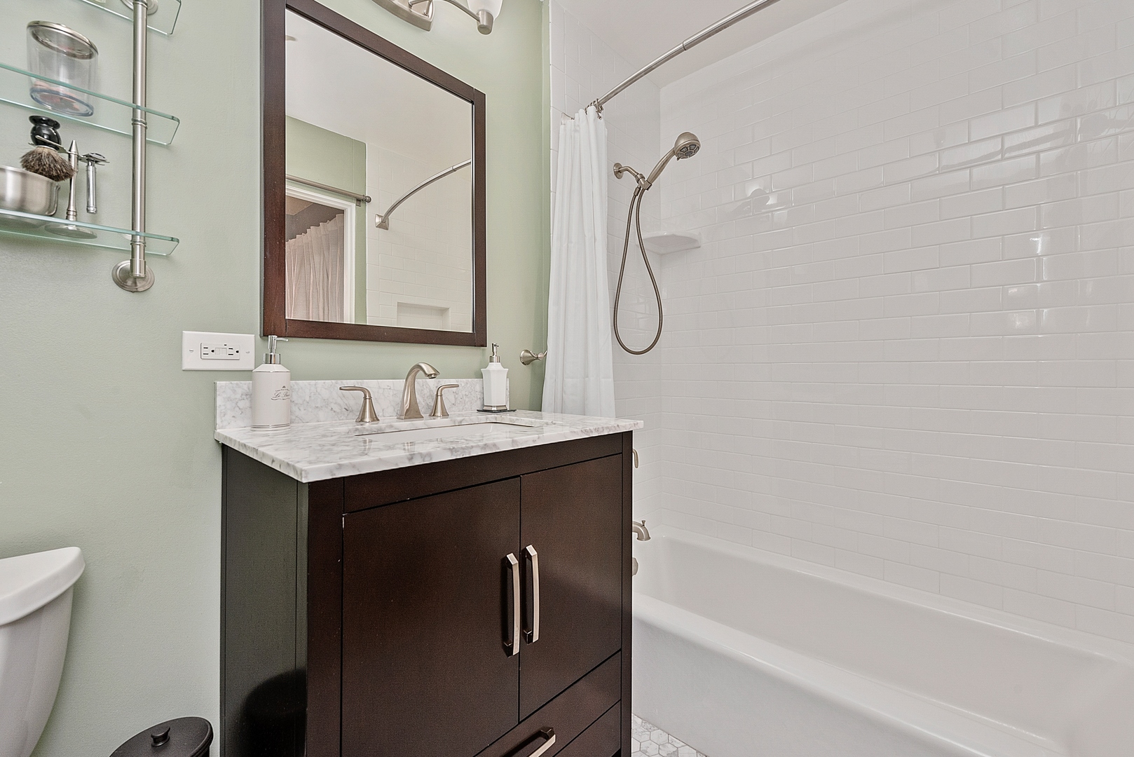 331 South Peoria Street, Unit 303 Chicago, IL 60607 - Photo 19 of 25 a bathroom with a granite countertop sink a toilet and a bathtub
