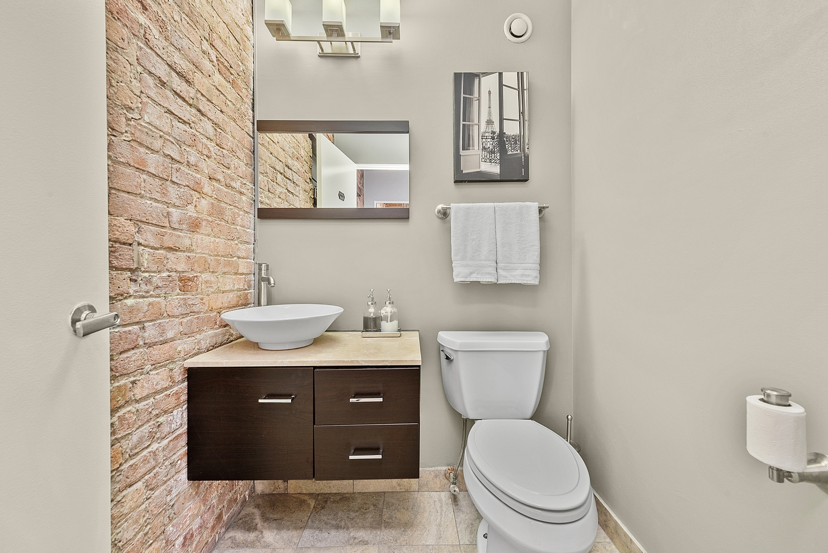 331 South Peoria Street, Unit 303 Chicago, IL 60607 - Photo 20 of 25 a bathroom with a granite countertop toilet sink and mirror