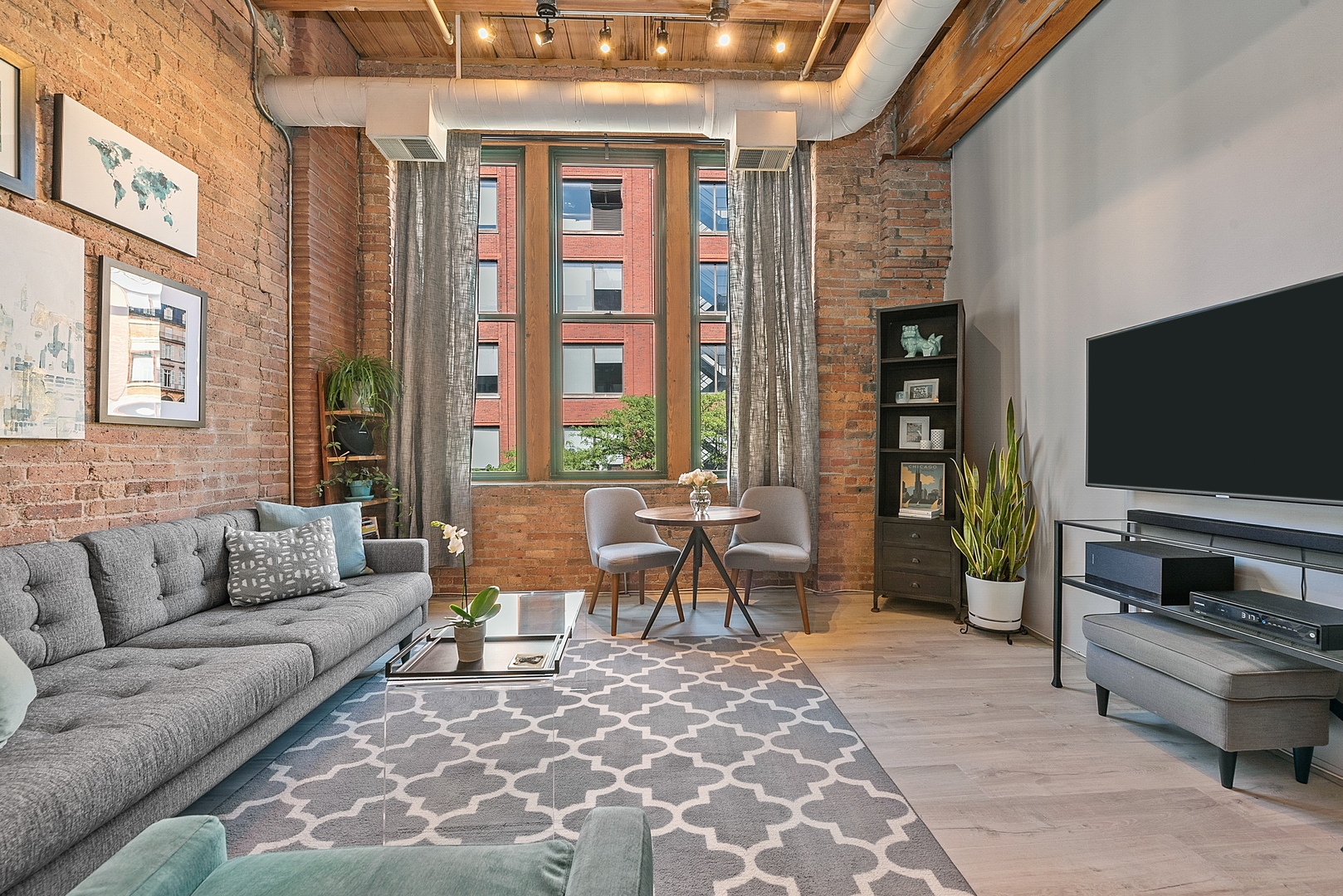 331 South Peoria Street, Unit 303 Chicago, IL 60607 - Photo 3 of 25 a living room with furniture and a flat screen tv