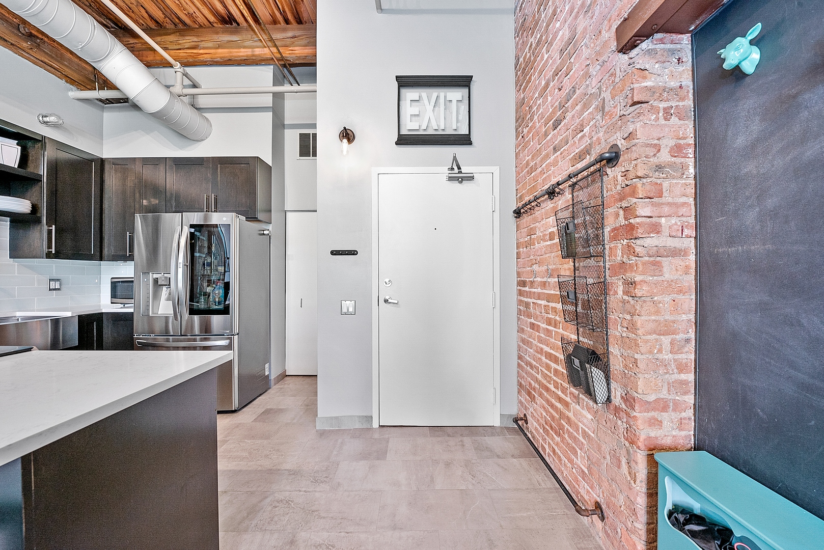 331 South Peoria Street, Unit 303 Chicago, IL 60607 - Photo 22 of 25 a view of a kitchen with refrigerator and cabinets