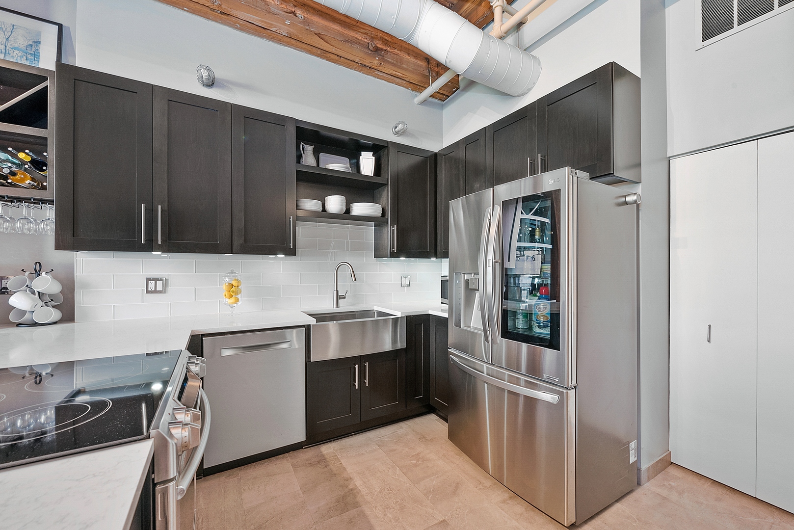 331 South Peoria Street, Unit 303 Chicago, IL 60607 - Photo 9 of 25 a kitchen with stainless steel appliances a sink cabinets and a refrigerator