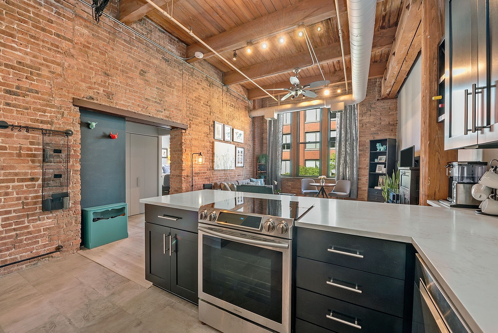 331 South Peoria Street, Unit 303 Chicago, IL 60607 - Photo 10 of 25 a kitchen with stainless steel appliances granite countertop a sink and a stove