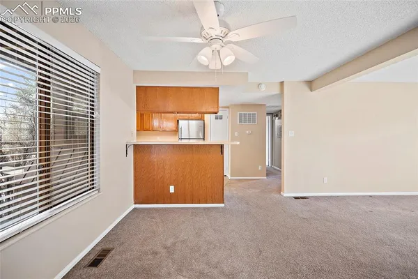 a view of an empty room with a fireplace