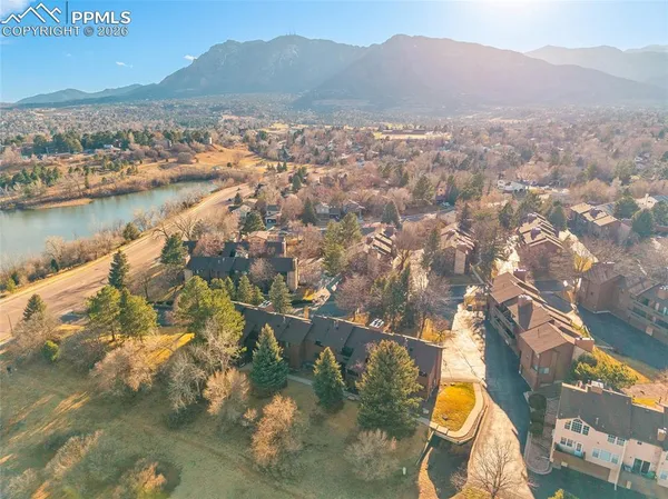 a view of residential houses with outdoor space and river