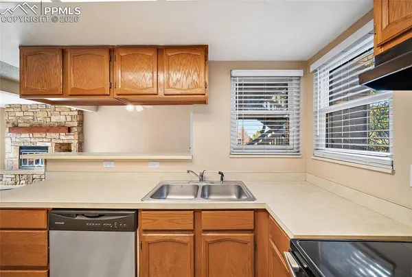 en empty room with a window and a kitchen