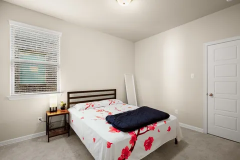 a bedroom with a bed and window