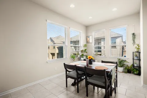 a dining room with a wooden table and chairs