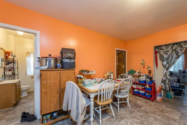 a dining room with furniture and a floor to ceiling window