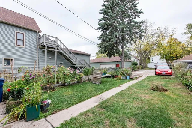 a view of house with garden space and street view