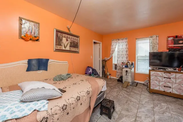 a bedroom with a bed and flat screen tv