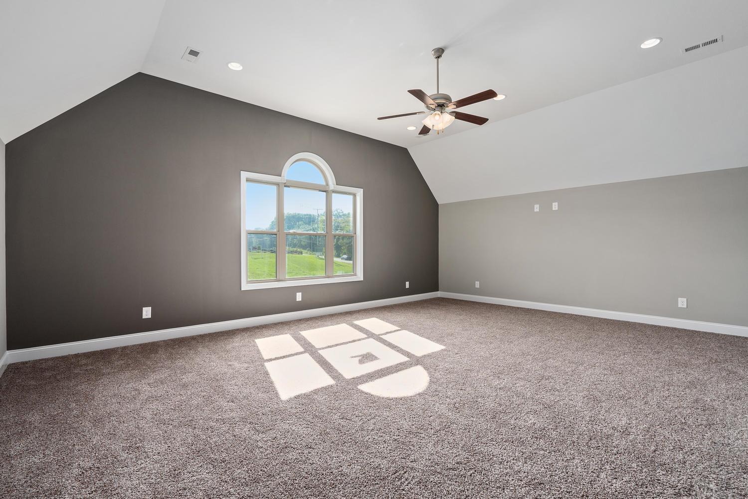 1003 Barnhill Road Clarksville, TN 37043 - Photo 4 of 5 an empty room with windows and ceiling fan