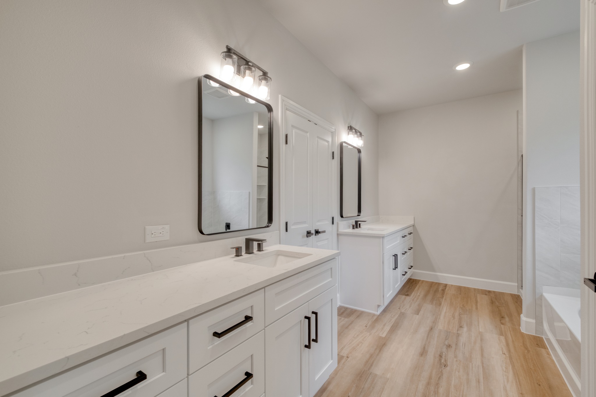 116 Pine Point Cove Elgin, TX 78621 - Photo 16 of 27 Dual vanity bathroom featuring light wood-finish flooring