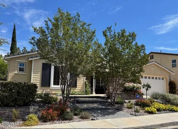 front view of a house with a tree