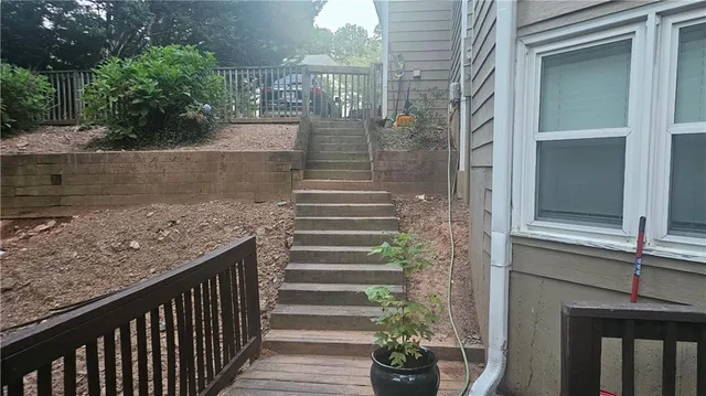 a view of a pathway of a house with potted plants