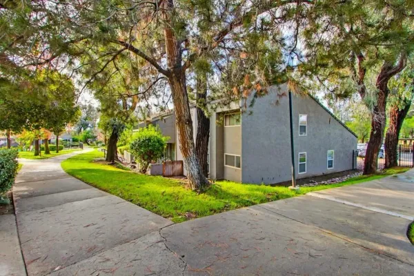 a front view of house with yard and green space