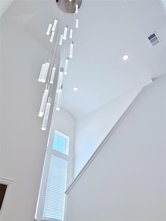 1336 Morning View Road Georgetown, TX 78628 - Photo 3 of 40 Dramatic two-story ceilings crown a sleek entry, illuminated by a contemporary cascading light fixture.