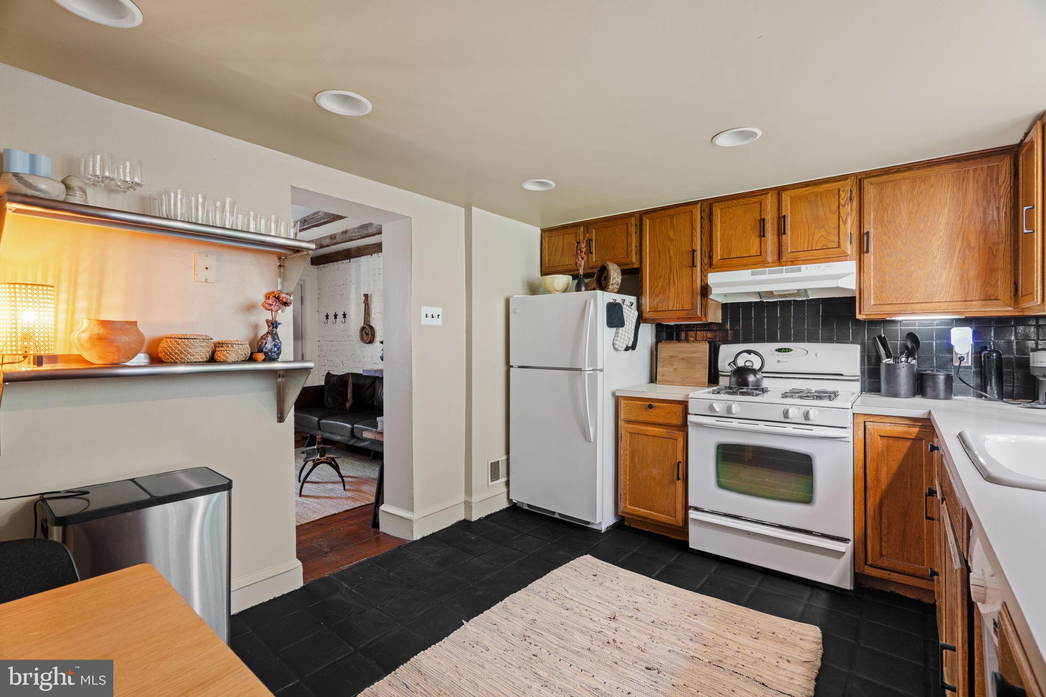 142 Carpenter Street Philadelphia, PA 19147 - Photo 22 of 49 a kitchen with stainless steel appliances a stove a refrigerator and a cabinets