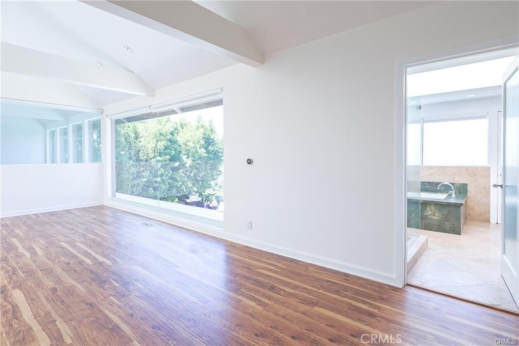 13425 Java Drive Beverly Hills, CA 90210 - Photo 19 of 28 an empty room with wooden floor and windows